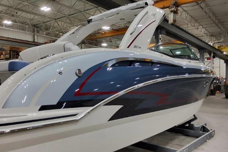 Slide: The Image of 2024 Formula 310 Sun Sport boat in a showroom, showcasing sleek design and vibrant colors. - 2