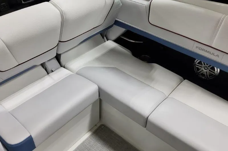 Slide: The Image of 2024 Formula 310 Sun Sport interior seating with white and blue upholstery. - 20