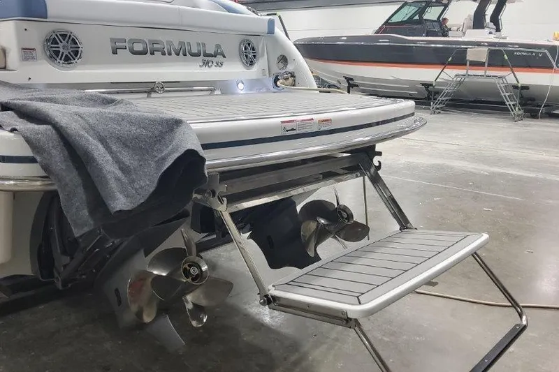 Slide: The Image of 2024 Formula 310 Sun Sport boat with swim platform and propellers in a showroom. - 22