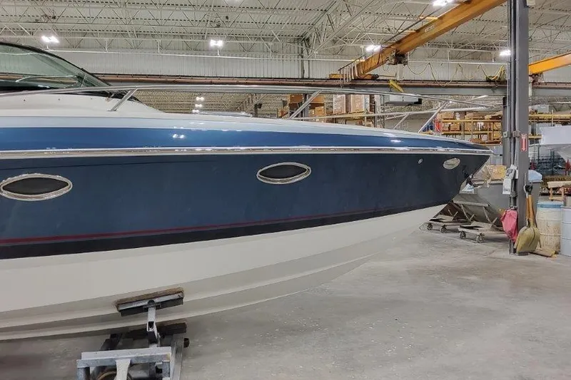 Slide: The Image of 2024 Formula 310 Sun Sport boat in a warehouse setting. - 3