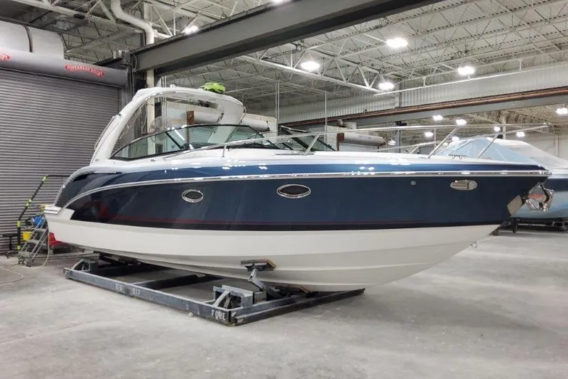 Slide: The Image of 2024 Formula 310 Sun Sport boat in a spacious indoor facility. - 4