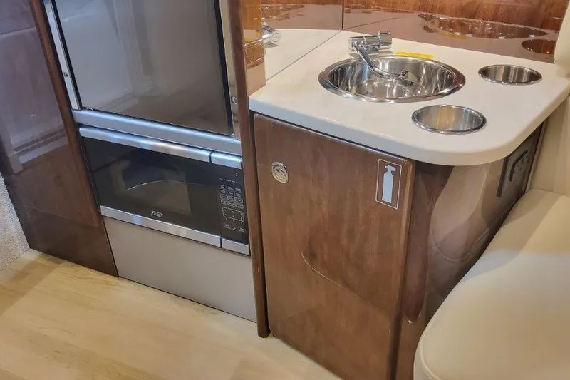 Slide: The Image of 2024 Formula 310 Sun Sport interior with kitchenette, featuring sink and appliances. - 41