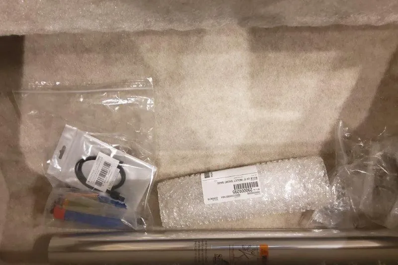 Slide: The Image of 2024 Formula 310 Sun Sport boat parts in packaging, including seals and wrapped components. - 43