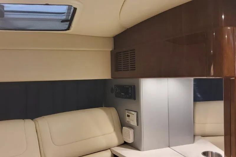 Slide: The Image of 2024 Formula 310 Sun Sport interior with beige seating and wood accents. - 45