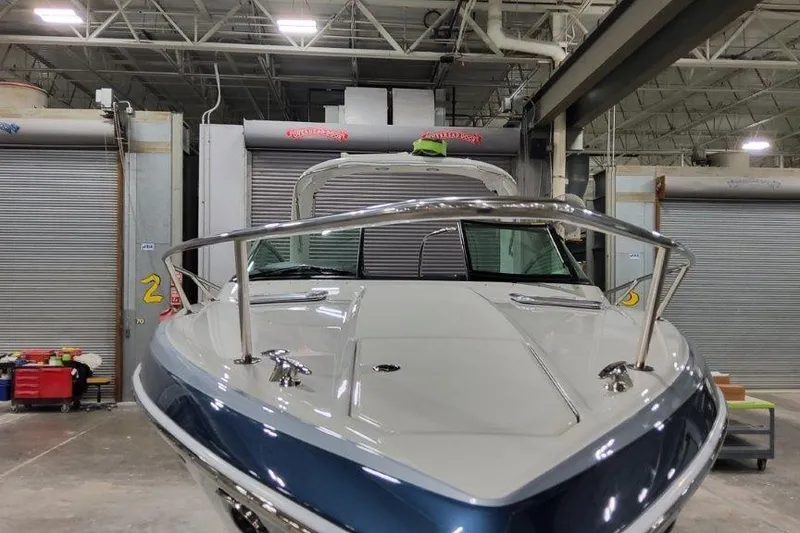 Slide: The Image of 2024 Formula 310 Sun Sport boat in a warehouse, showcasing sleek design and modern features. - 5