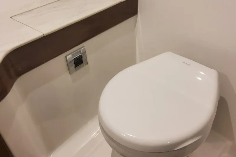 Slide: The Image of 2024 Formula 310 Sun Sport boat bathroom with modern toilet design. - 51