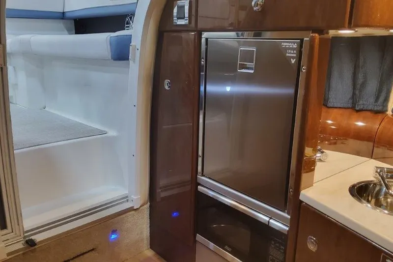 Slide: The Image of 2024 Formula 310 Sun Sport interior with kitchenette and seating area. - 53