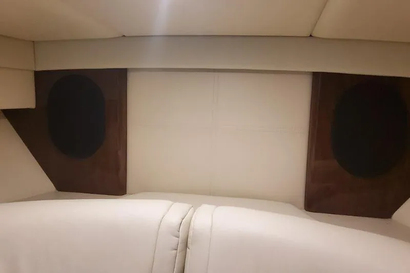 Slide: The Image of 2024 Formula 310 Sun Sport interior with beige upholstery and wooden accents. - 54