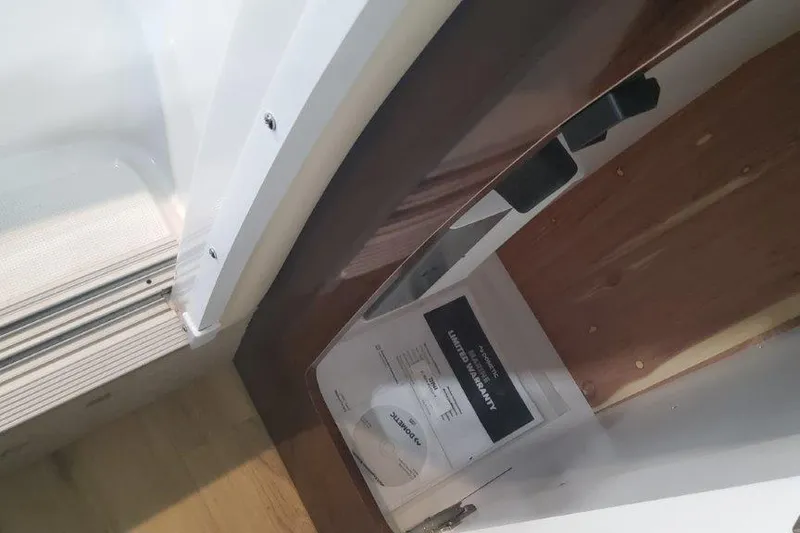 Slide: The Image of 2024 Formula 310 Sun Sport interior detail with wood finish and manual. - 56