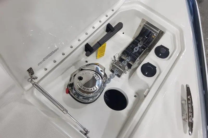 Slide: The Image of 2024 Formula 310 Sun Sport boat anchor compartment with winch and chain storage. - 57
