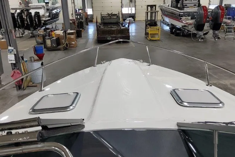 Slide: The Image of 2024 Formula 310 Sun Sport boat in a workshop, showcasing sleek design and modern features. - 9