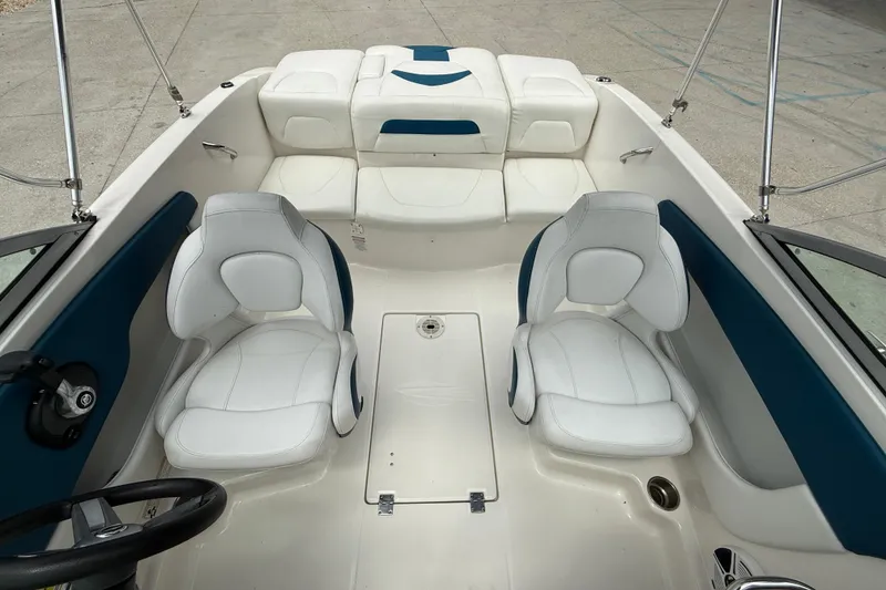Slide: The Image of 2016 Chaparral 19 H2O Sport boat interior with white and blue seating. - 10