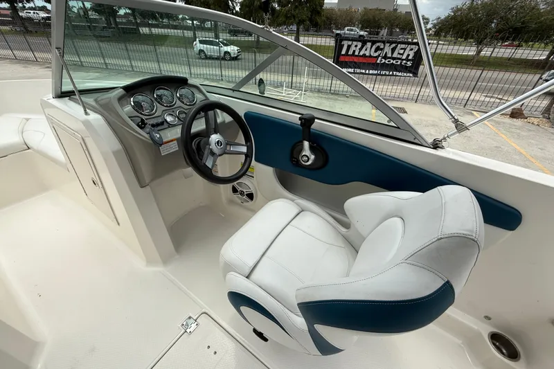 Slide: The Image of 2016 Chaparral 19 H2O Sport boat interior with steering wheel and dashboard controls. - 11