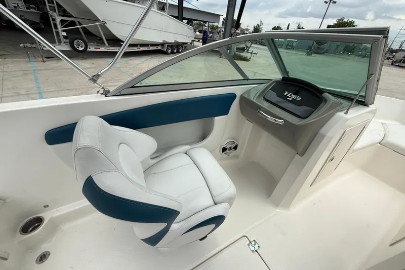 Slide: The Image of 2016 Chaparral 19 H2O Sport boat interior with white and blue seating. - 12