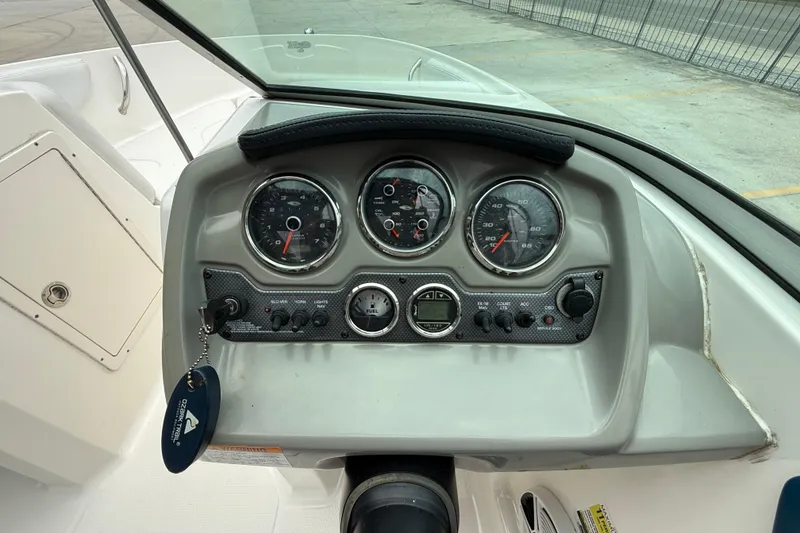 Slide: The Image of 2016 Chaparral 19 H2O Sport dashboard with gauges and controls. - 13