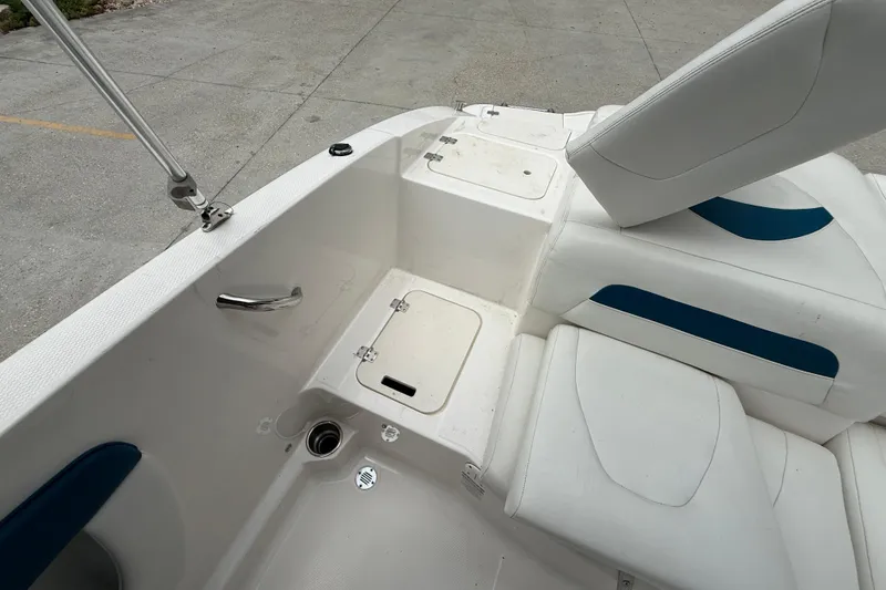 Slide: The Image of 2016 Chaparral 19 H2O Sport boat interior with white and blue seating. - 14