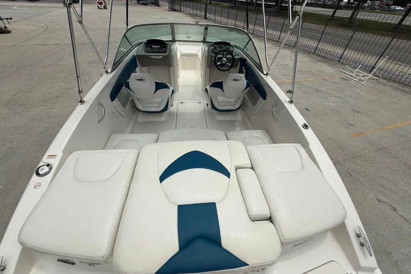 Slide: The Image of 2016 Chaparral 19 H2O Sport boat interior with white and blue seating. - 7
