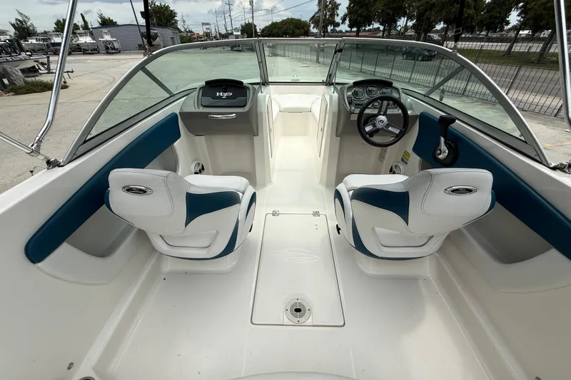 Slide: The Image of 2016 Chaparral 19 H2O Sport boat interior with dual seats and steering wheel. - 8