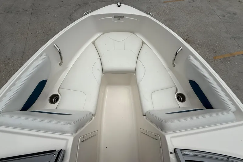 Slide: The Image of 2016 Chaparral 19 H2O Sport boat interior with white seating and cup holders. - 9