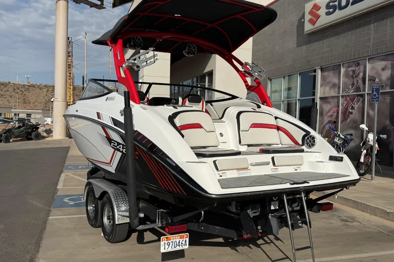 Slide: The Image of 2019 Yamaha Boats 242X E-Series on trailer, parked outside dealership. - 12