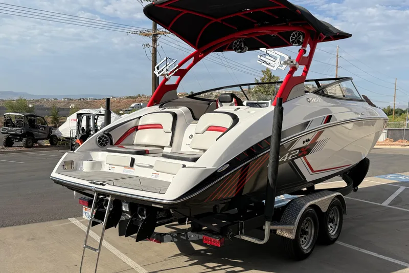 Slide: The Image of 2019 Yamaha Boats 242X E-Series on trailer, featuring sleek design and vibrant red accents. - 14