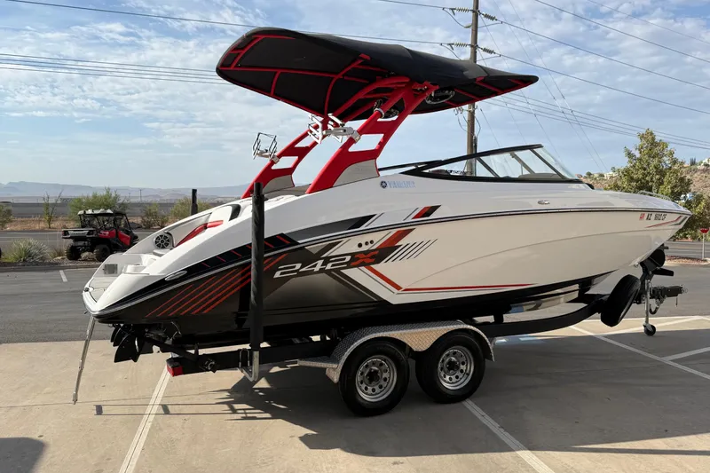 Slide: The Image of 2019 Yamaha Boats 242X E-Series on trailer, featuring sleek design and vibrant graphics. - 15