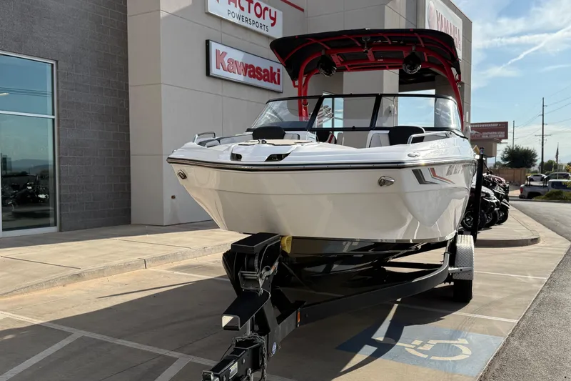 Slide: The Image of 2019 Yamaha Boats 242X E-Series displayed outside dealership. - 22