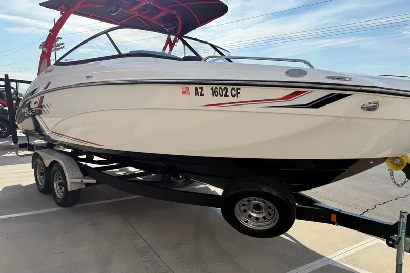 Slide: The Image of 2019 Yamaha Boats 242X E-Series on trailer, sleek design, vibrant graphics. - 24