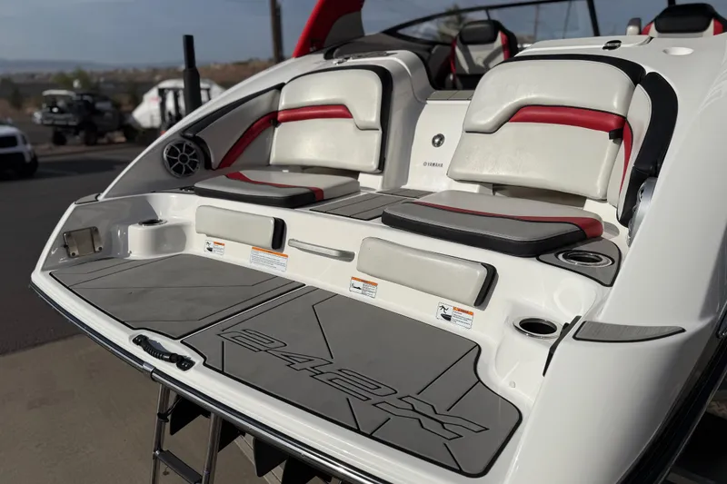 Slide: The Image of 2019 Yamaha Boats 242X E-Series swim platform with cushioned seating and cup holders. - 30