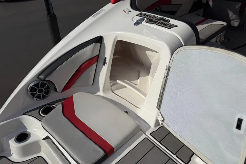 Slide: The Image of 2019 Yamaha Boats 242X E-Series interior with storage compartment and seating. - 31