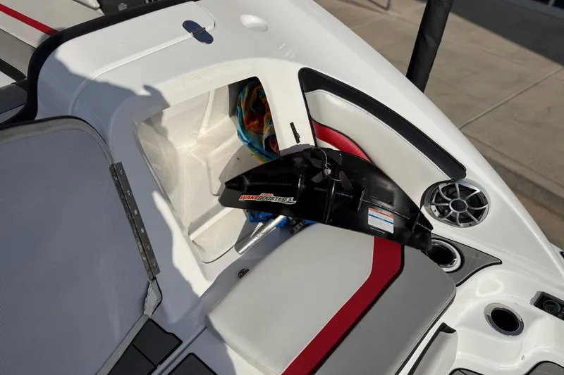 Slide: The Image of 2019 Yamaha Boats 242X E-Series interior with storage compartment and speaker. - 32