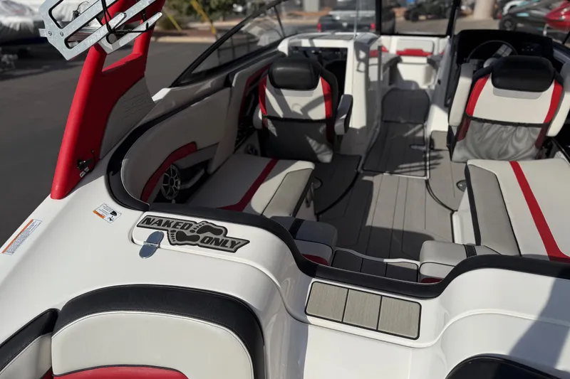 Slide: The Image of 2019 Yamaha Boats 242X E-Series interior with red and black seating, "Naked Only" decal. - 33