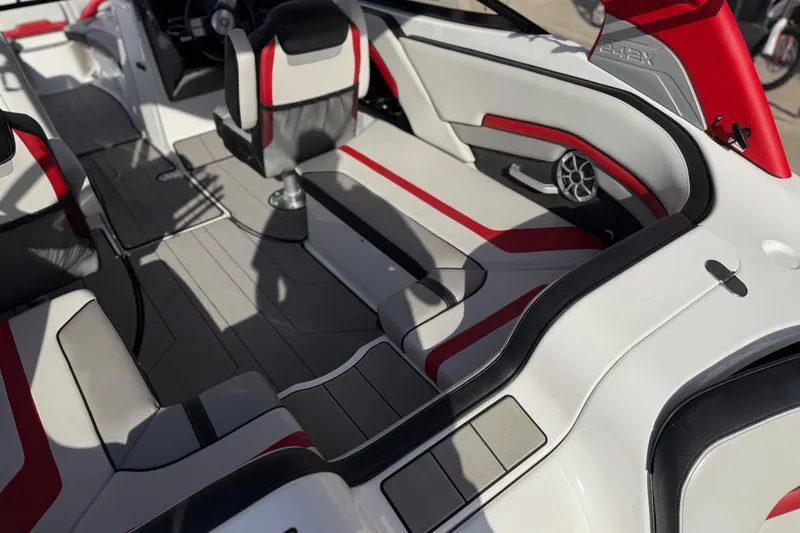 Slide: The Image of 2019 Yamaha Boats 242X E-Series interior with red and white seating, modern design. - 34
