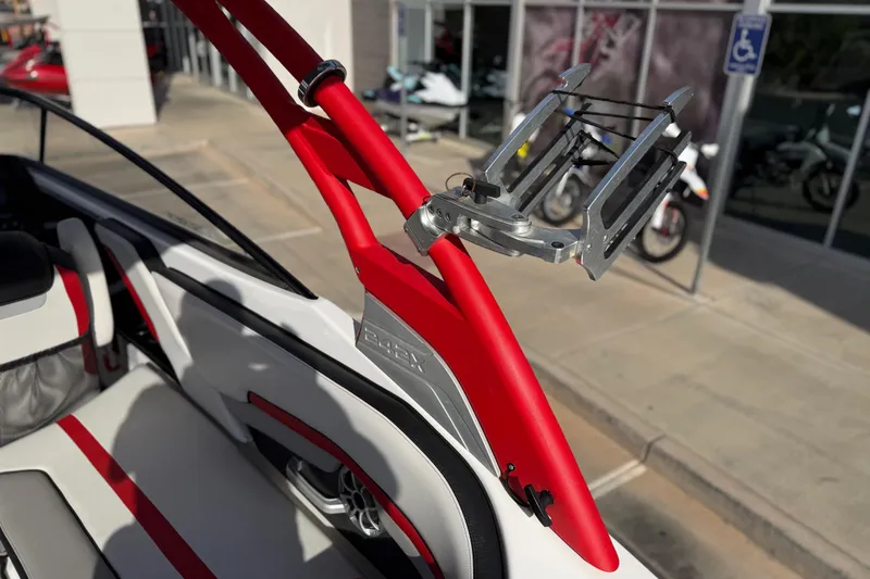 Slide: The Image of 2019 Yamaha Boats 242X E-Series interior with red accents and wakeboard rack. - 36