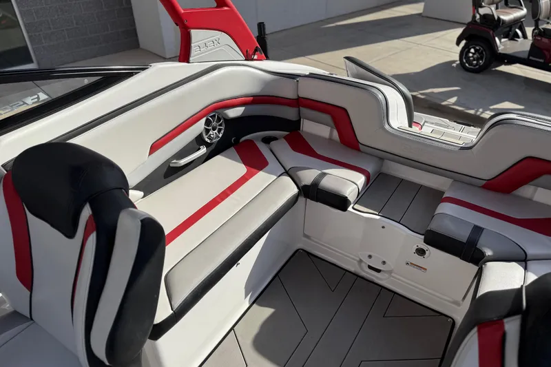 Slide: The Image of 2019 Yamaha Boats 242X E-Series interior with red and black seating accents. - 39