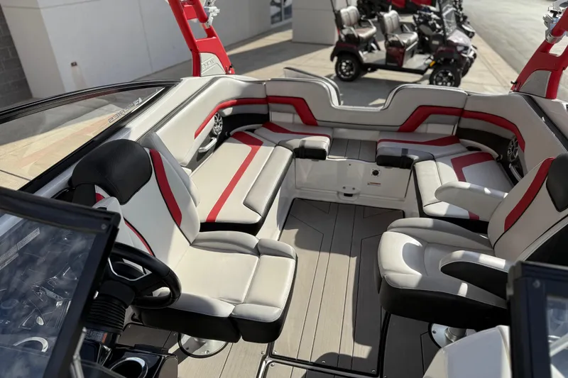Slide: The Image of 2019 Yamaha Boats 242X E-Series interior with red and white seating, steering wheel, and spacious layout. - 41