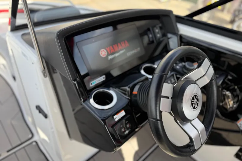 Slide: The Image of 2019 Yamaha Boats 242X E-Series dashboard with steering wheel and touchscreen display. - 44