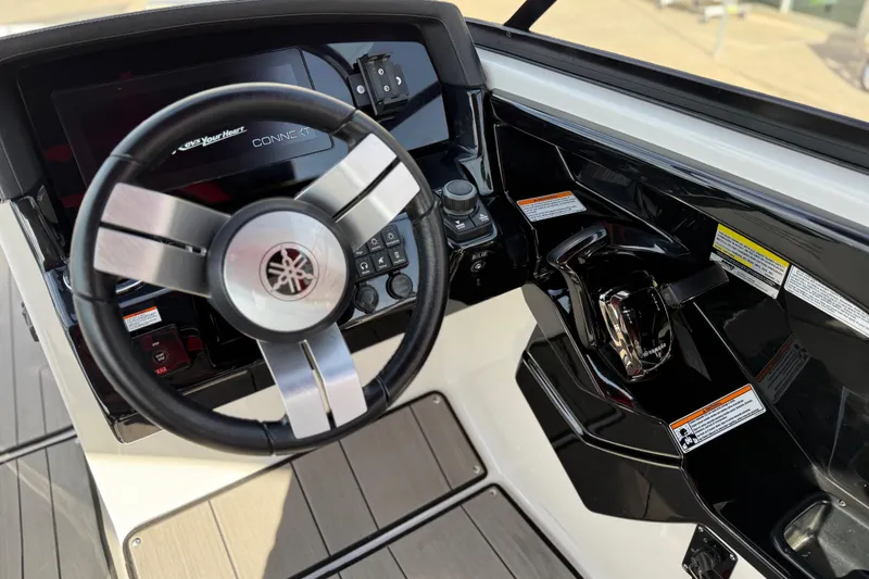 Slide: The Image of 2019 Yamaha Boats 242X E-Series steering console with modern controls and sleek design. - 45