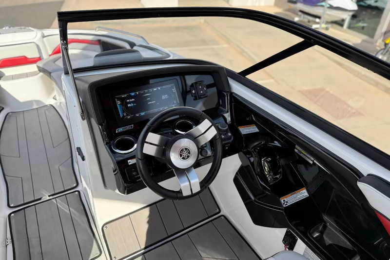 Slide: The Image of 2019 Yamaha Boats 242X E-Series cockpit with modern steering and dashboard controls. - 48