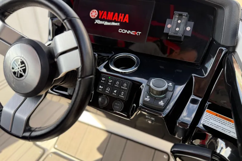 Slide: The Image of Steering console of 2019 Yamaha Boats 242X E-Series with control panel and display. - 49