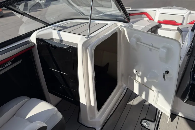 Slide: The Image of 2019 Yamaha Boats 242X E-Series interior cabin with open storage compartment. - 53