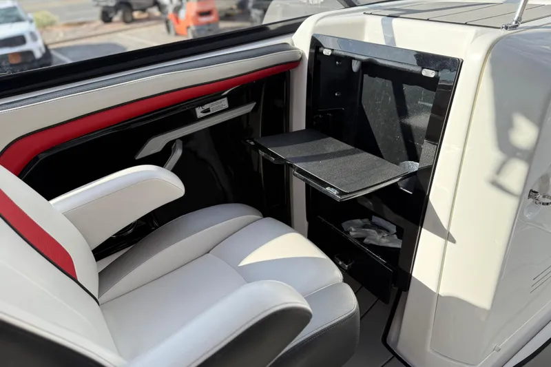 Slide: The Image of 2019 Yamaha Boats 242X E-Series interior with white and red seating, foldable table. - 54