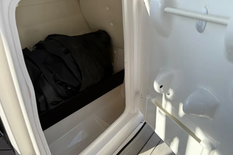 Slide: The Image of Storage compartment in 2019 Yamaha Boats 242X E-Series, featuring interior space and equipment. - 58