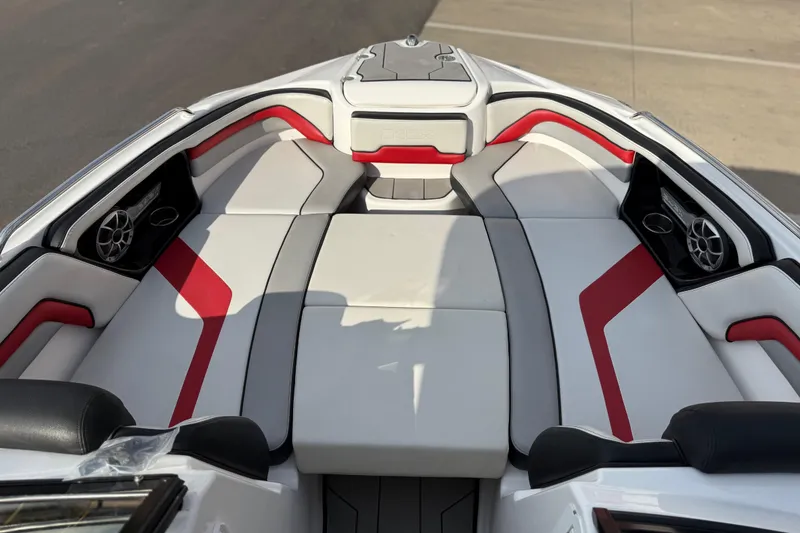 Slide: The Image of 2019 Yamaha Boats 242X E-Series interior with red and white seating, featuring speakers. - 62