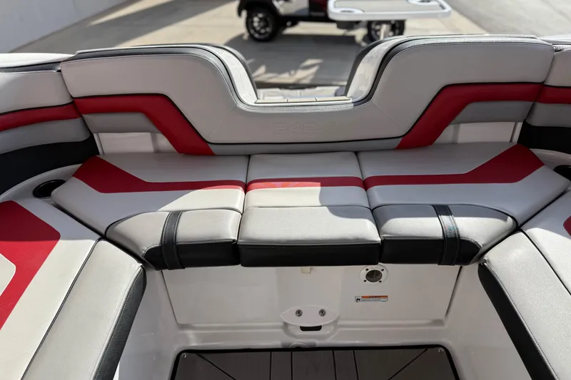 Slide: The Image of 2019 Yamaha Boats 242X E-Series interior with red and gray seating. - 65