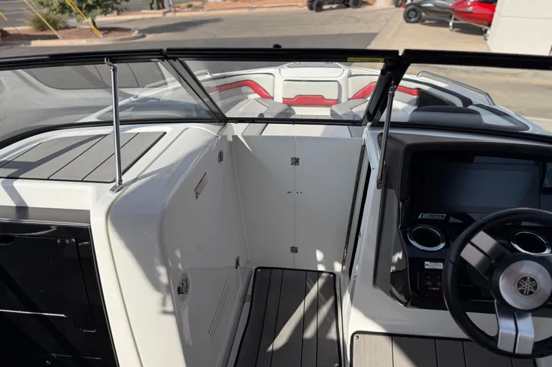 Slide: The Image of 2019 Yamaha Boats 242X E-Series interior with steering wheel and seating area. - 67