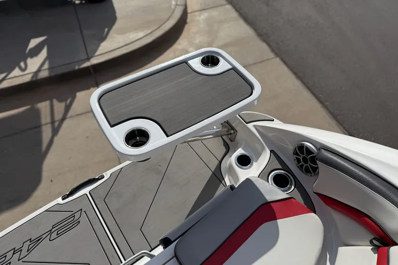 Slide: The Image of 2019 Yamaha Boats 242X E-Series interior with table and cup holders. - 70