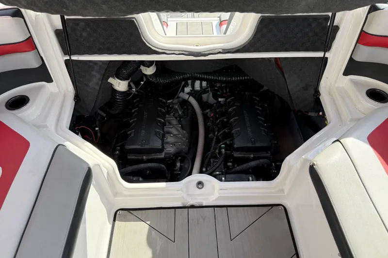 Slide: The Image of 2019 Yamaha Boats 242X E-Series engine compartment with dual engines and seating area. - 71