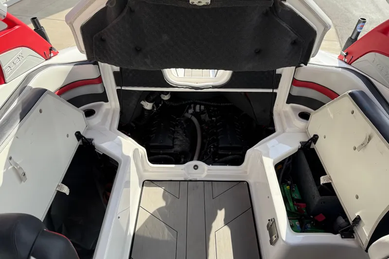 Slide: The Image of 2019 Yamaha Boats 242X E-Series engine compartment with open storage hatches. - 74