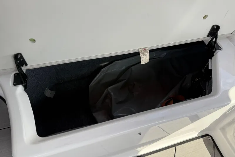 Slide: The Image of Open storage compartment on 2019 Yamaha Boats 242X E-Series. - 76